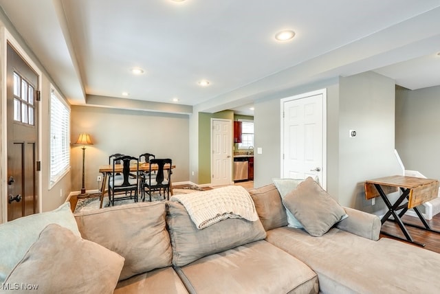 living area featuring light wood-style flooring, a wealth of natural light, and recessed lighting