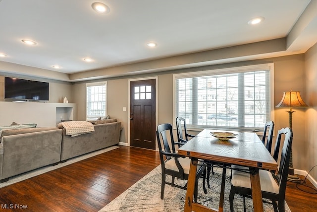 dining area with baseboards, dark wood-style flooring, and recessed lighting