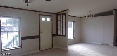 empty room with ornamental molding and a ceiling fan