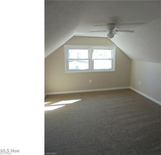 bonus room with a ceiling fan, carpet, vaulted ceiling, and baseboards