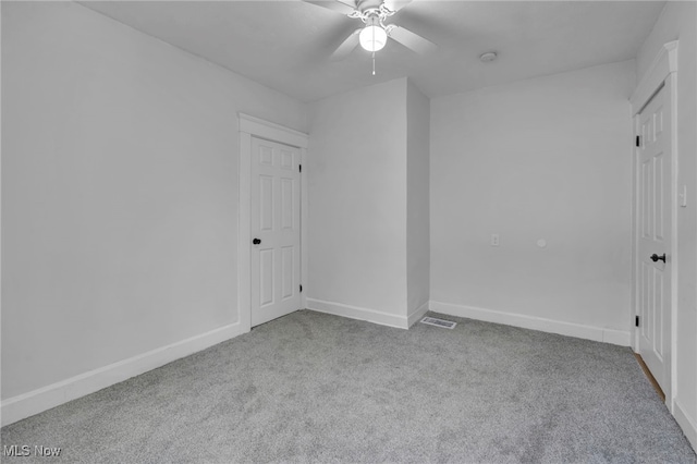 unfurnished bedroom with light carpet, ceiling fan, and baseboards