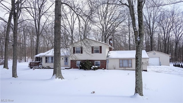 tri-level home with brick siding and a detached garage