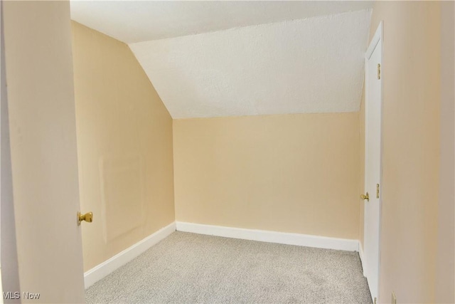 bonus room featuring vaulted ceiling, carpet floors, and baseboards