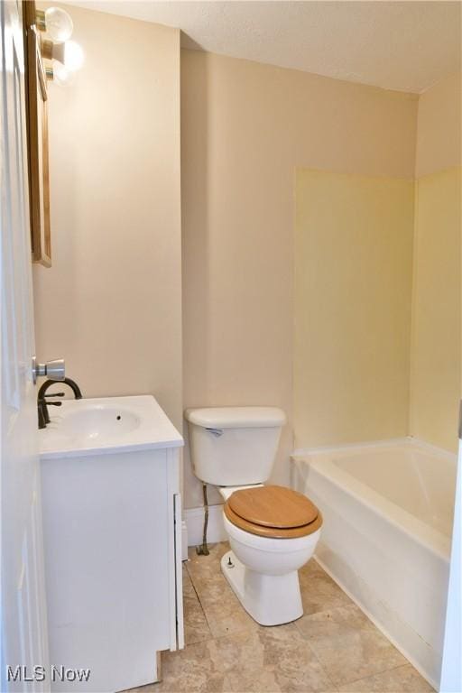 full bathroom featuring vanity, toilet, and a tub