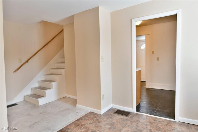 stairs with visible vents and baseboards