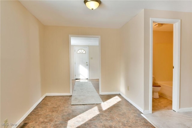 foyer entrance with visible vents and baseboards