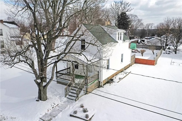 view of snowy exterior with a chimney