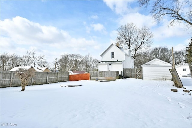 yard layered in snow with fence