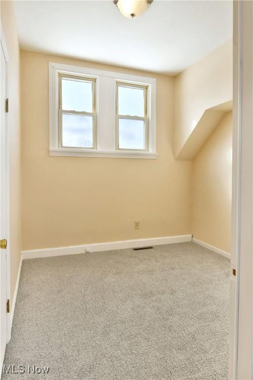 bonus room with carpet flooring, visible vents, and baseboards