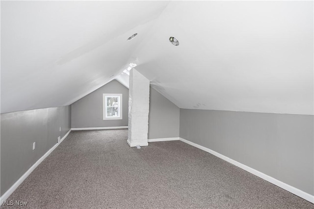 bonus room featuring lofted ceiling, baseboards, and carpet flooring