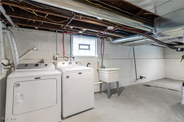 clothes washing area featuring laundry area and washing machine and clothes dryer