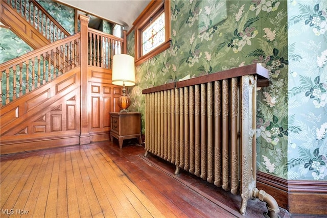 interior space featuring dark wood-style flooring and wallpapered walls