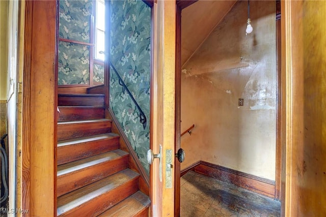 staircase featuring wallpapered walls