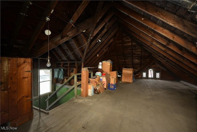 unfinished attic with an upstairs landing