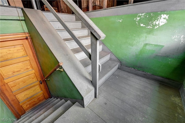 stairs featuring wood finished floors