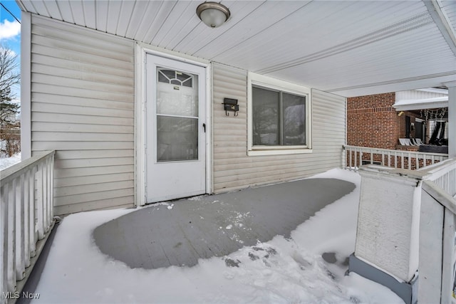 view of snow covered property entrance