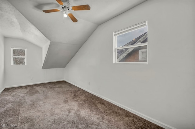 bonus room featuring carpet floors, baseboards, a ceiling fan, and lofted ceiling