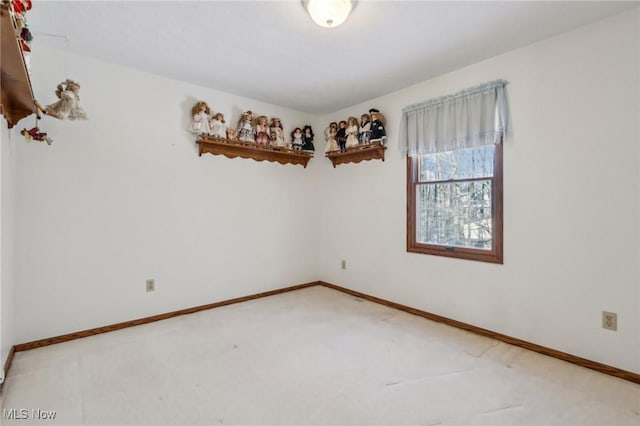 empty room with carpet and baseboards