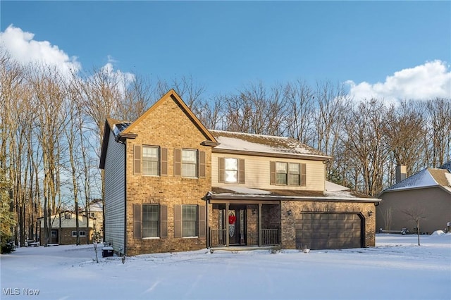 traditional-style home with a garage and brick siding