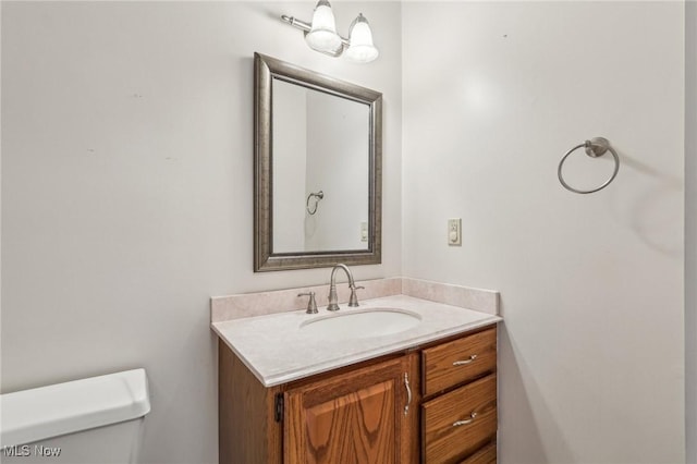 half bath featuring toilet and vanity