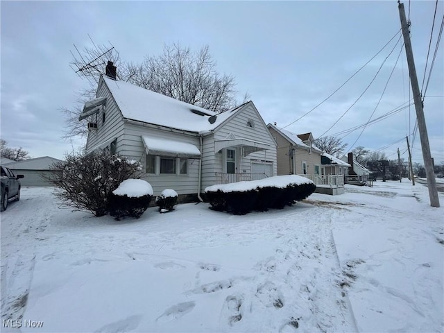 view of front of property featuring a garage and a chimney