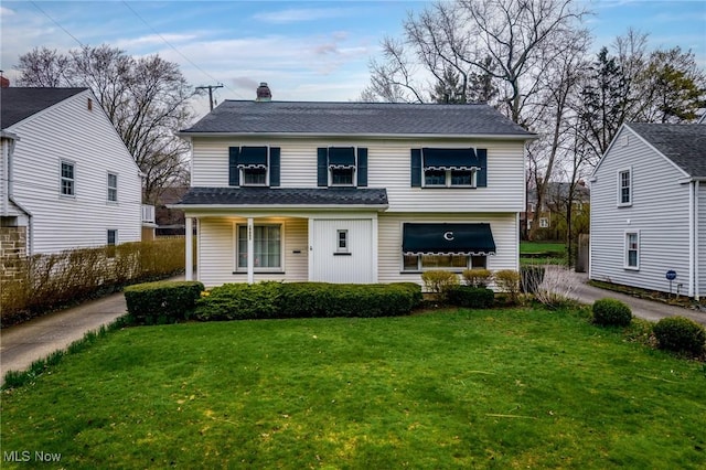 19951 Fairmount Blvd, Shaker Heights, OH 44118 - view of front of home with a front lawn, a chimney, and roof with shingles