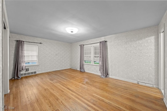 19951 Fairmount Blvd, Shaker Heights, OH 44118 - empty room with light wood-style flooring, healthy amount of natural light, wallpapered walls, and baseboards