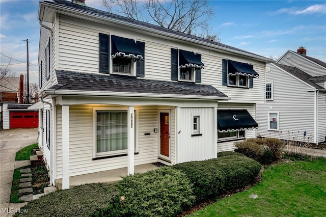 19951 Fairmount Blvd, Shaker Heights, OH 44118 - view of front of property featuring an outdoor structure, a chimney, a garage, and a shingled roof