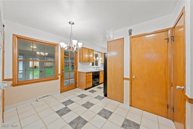 19951 Fairmount Blvd, Shaker Heights, OH 44118 - kitchen featuring black dishwasher, a chandelier, light countertops, light tile patterned flooring, and brown cabinetry