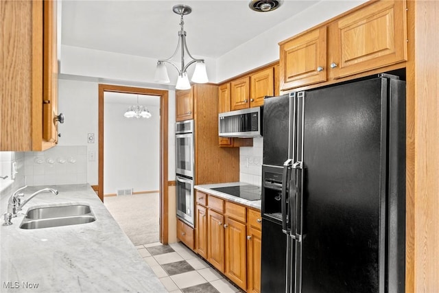 19951 Fairmount Blvd, Shaker Heights, OH 44118 - kitchen with black appliances, a sink, a chandelier, and tasteful backsplash