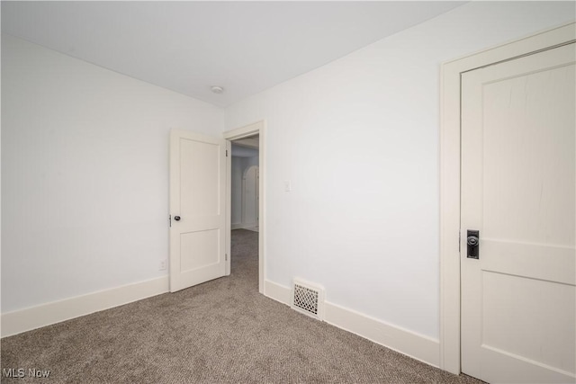 unfurnished bedroom featuring carpet, visible vents, and baseboards