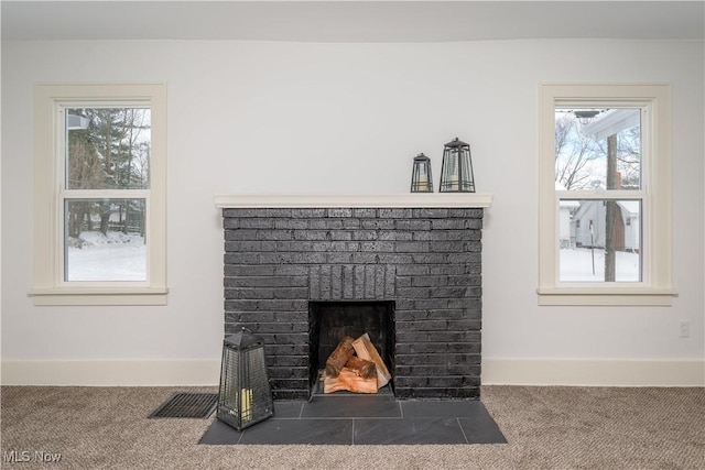 interior details with carpet, visible vents, a fireplace, and baseboards