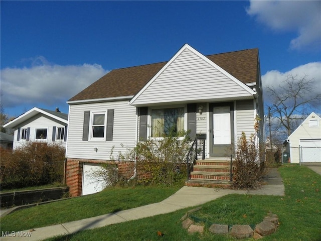 view of front of house featuring a garage, roof with shingles, a front lawn, and brick siding