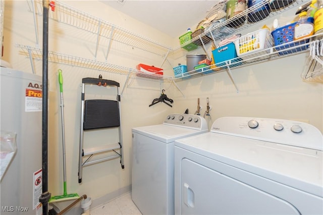 laundry area featuring laundry area, water heater, and independent washer and dryer