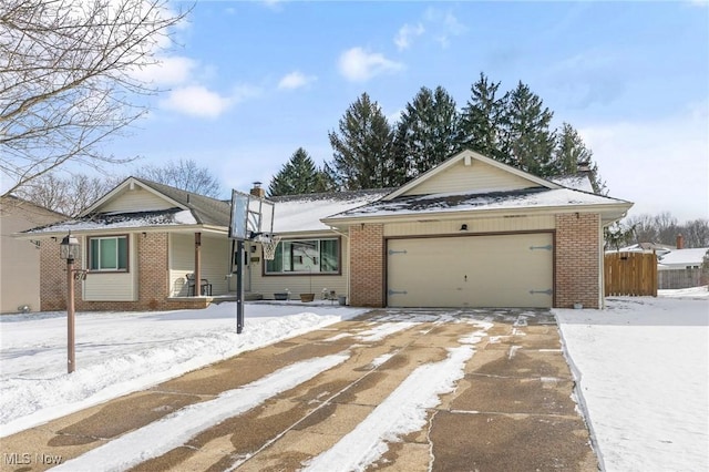 ranch-style house featuring a garage, concrete driveway, and brick siding