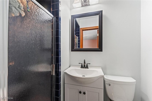 full bathroom with toilet, a shower with door, and vanity