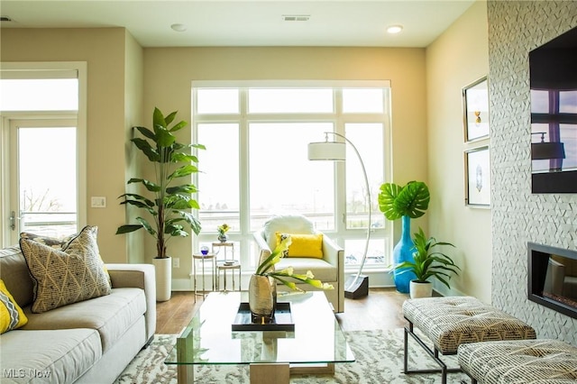 sunroom featuring visible vents and a stone fireplace