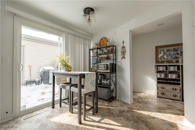 dining room featuring visible vents and baseboards