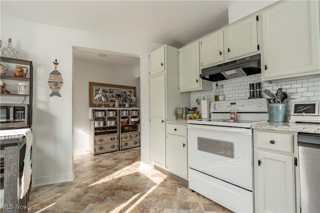 kitchen featuring under cabinet range hood, stainless steel appliances, baseboards, decorative backsplash, and stone finish flooring