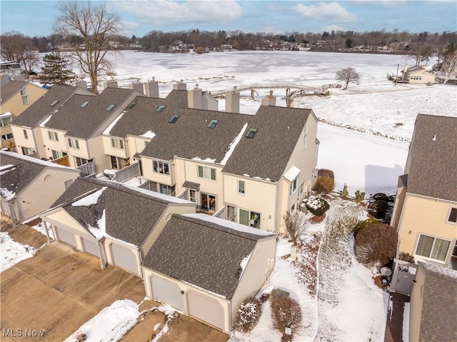 snowy aerial view featuring a residential view