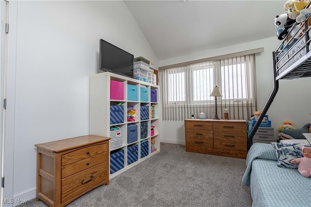 bedroom featuring light colored carpet and vaulted ceiling