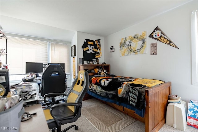 bedroom featuring light carpet