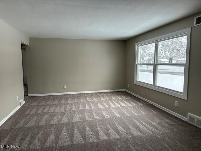 carpeted empty room with baseboards and visible vents