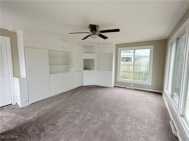 interior space with carpet flooring and ceiling fan