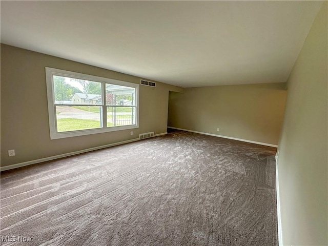 carpeted empty room with visible vents and baseboards