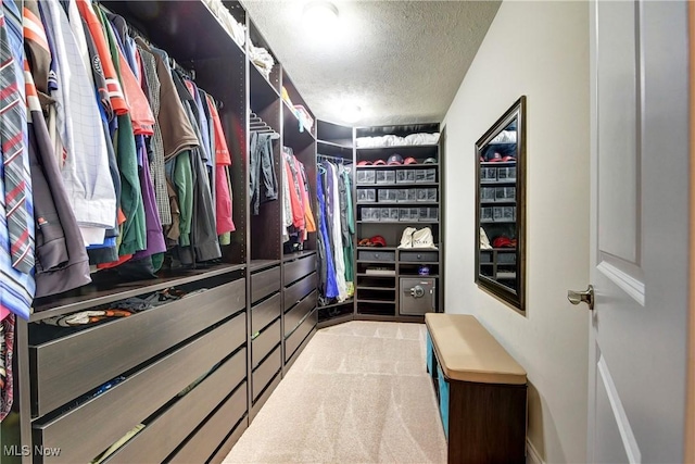 walk in closet featuring light carpet