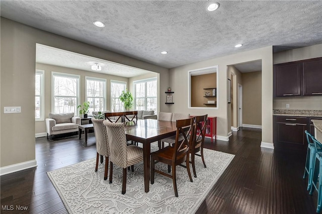 dining space with dark wood-style floors, recessed lighting, a textured ceiling, and baseboards