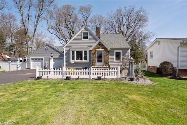 view of front facade featuring a garage, a chimney, roof with shingles, fence, and a front lawn