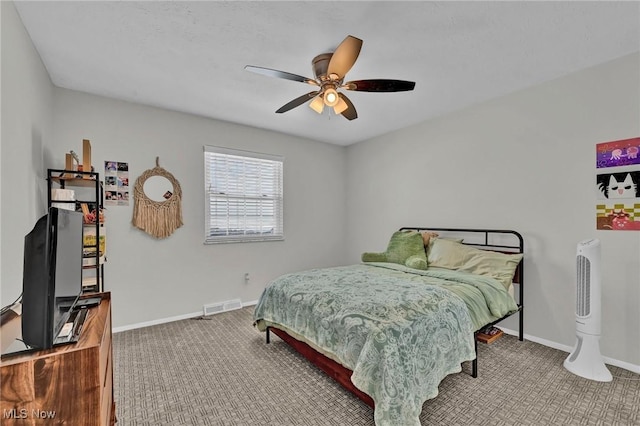 carpeted bedroom with ceiling fan, visible vents, and baseboards