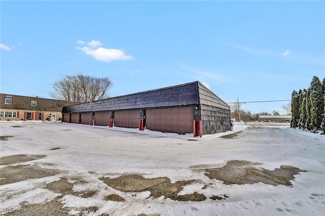 snow covered structure featuring an outdoor structure